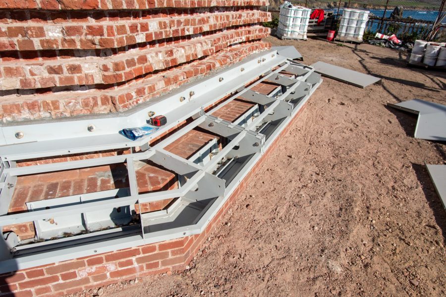 Marine-grade stainless steel replacement parts are installed to recreate the belt courses of the lighthouse.